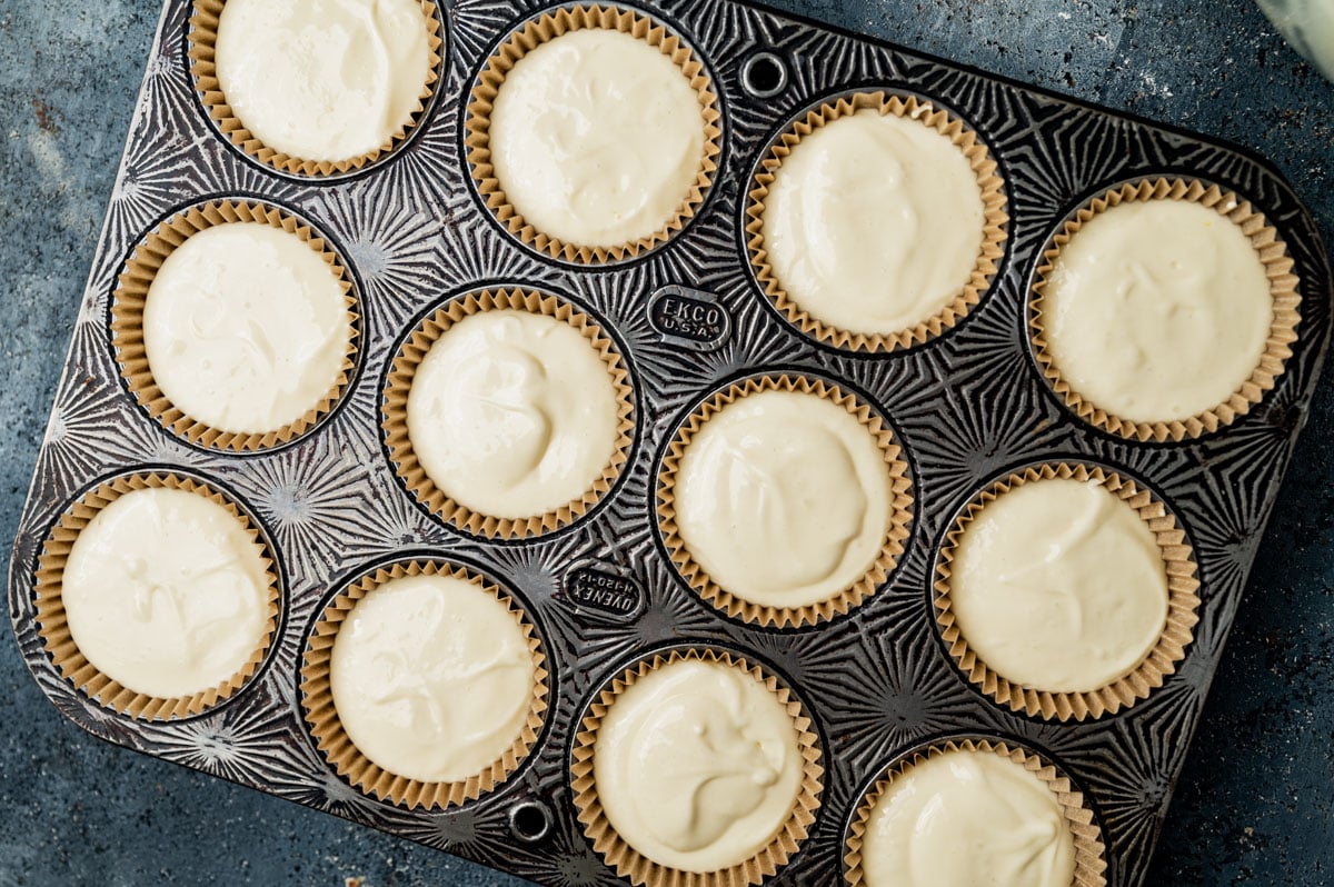 unbaked mini cheesecakes in a muffin pan