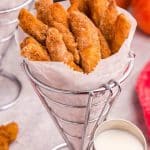 a wire cone of Air Fryer Apple Fries with vanilla glaze on the side