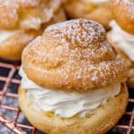 a cream puff filled with whipped cream on a wire rack