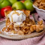 a piece of homemade apple pie with ice cream on a plate