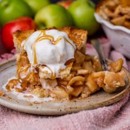 a piece of homemade apple pie with ice cream on a plate