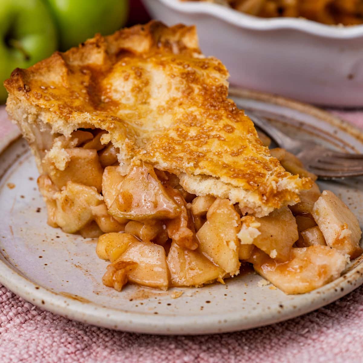 a piece of homemade apple pie on a plate