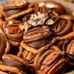 a bowl full of rolo turtles with pretzels