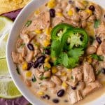 a bowl of white chicken chili with jalapenos and cilantro