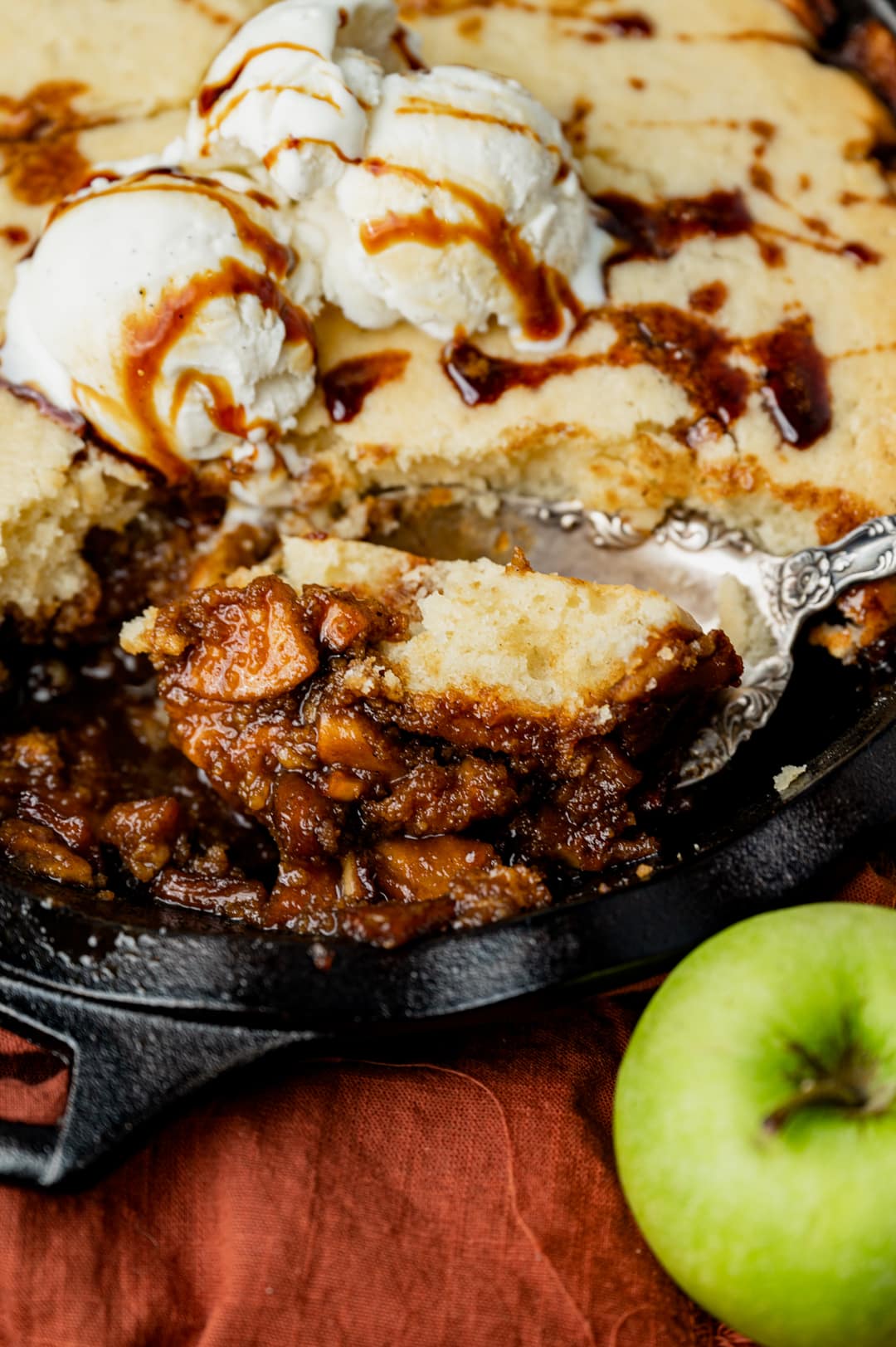 a spoonful of cinnamon fried apples with cobbler topping