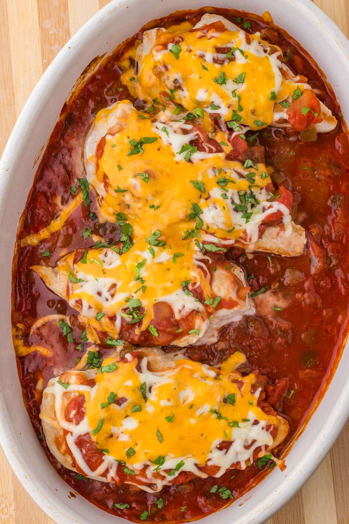 overhead view of baked chicken breasts in a dish