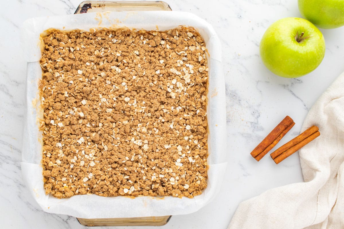 unbaked caramel apple cheesecake bars in a pan