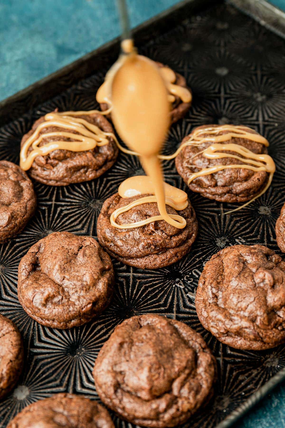 drizzling caramel on top of a cookie