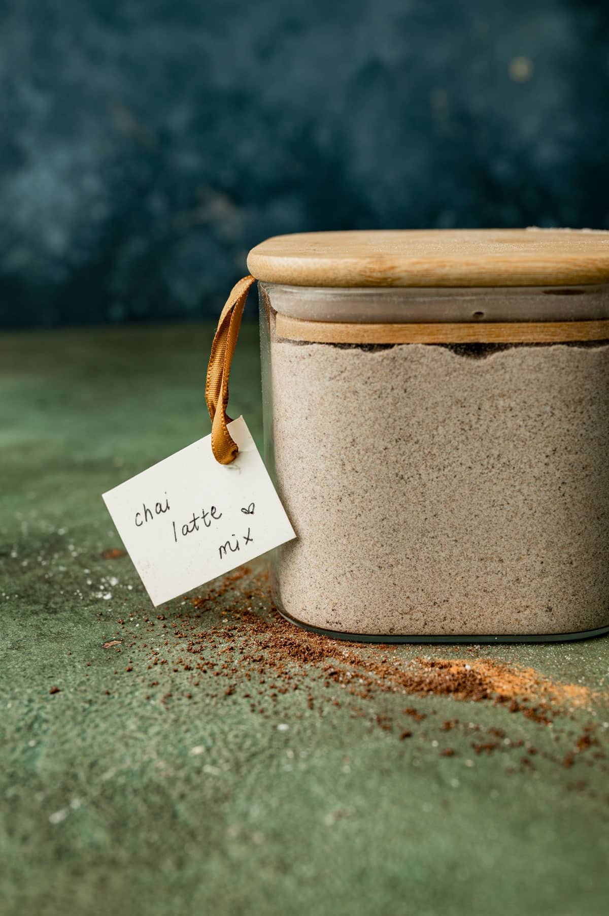 homemade chai latte mix in a glass container on a table