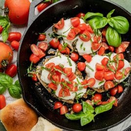 overhead view of chicken margherita in a cast iron pan