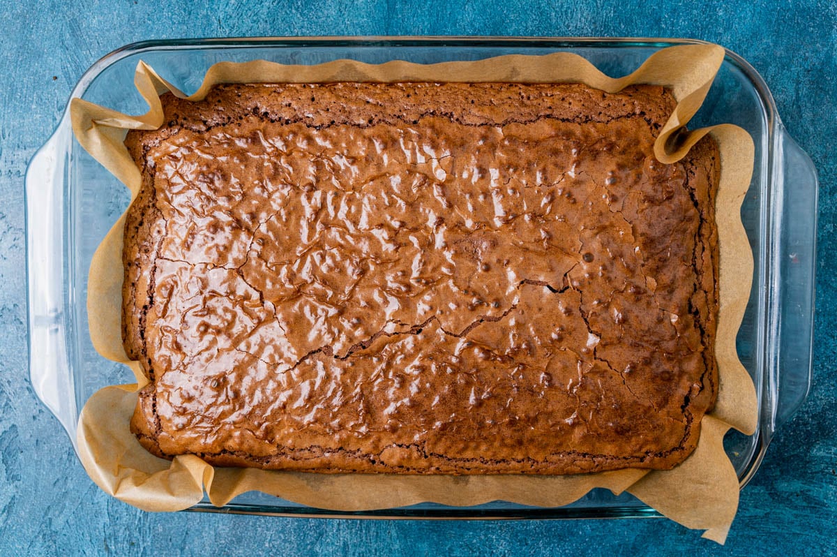 cake like brownies in a glass pan with parchment