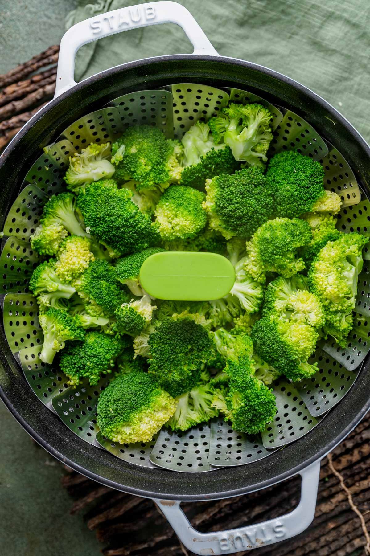 steamed broccoli in a steamer basket