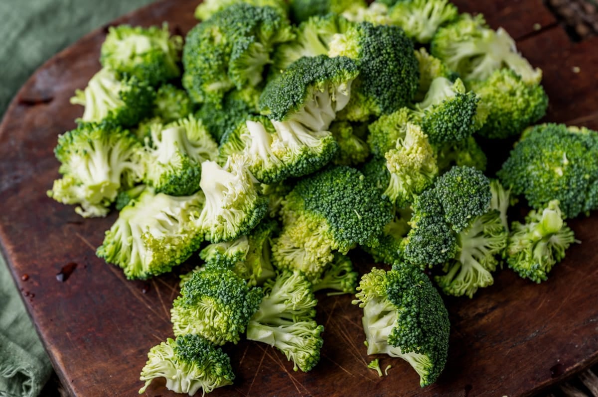 cut broccoli florets on a board
