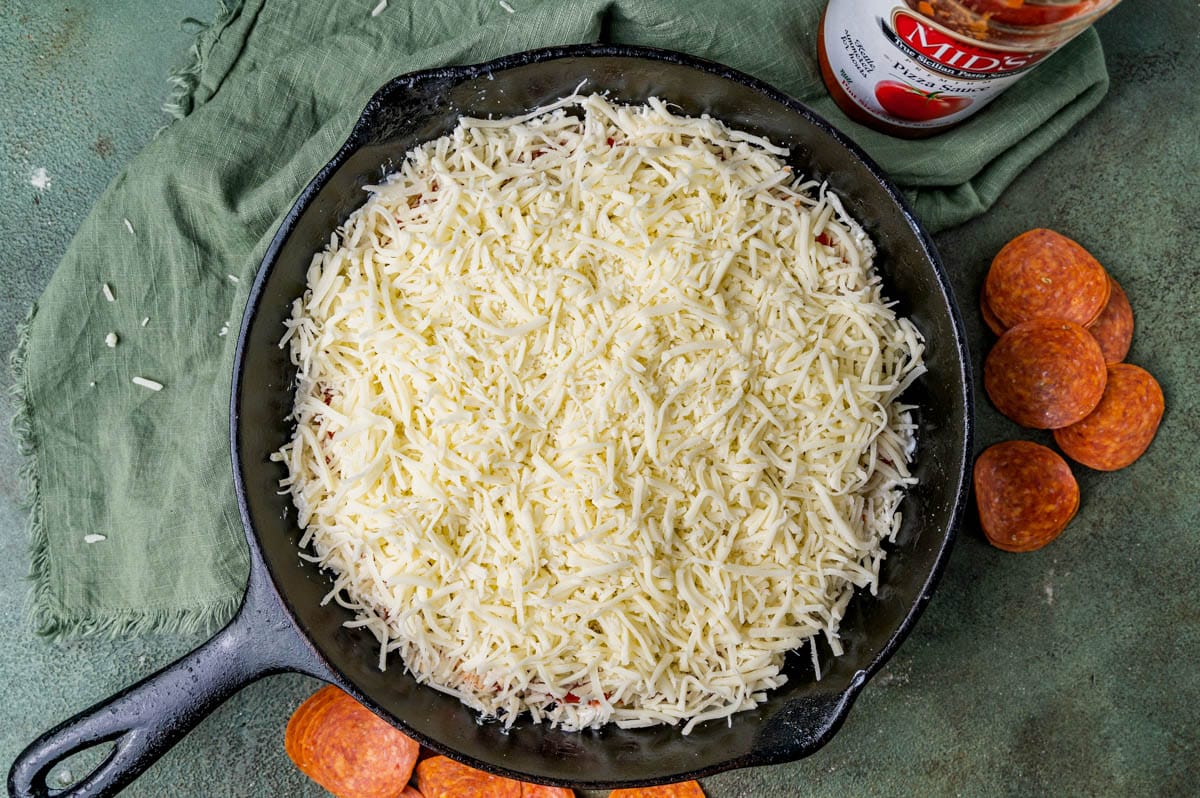 shredded italian cheese in a skillet on a table