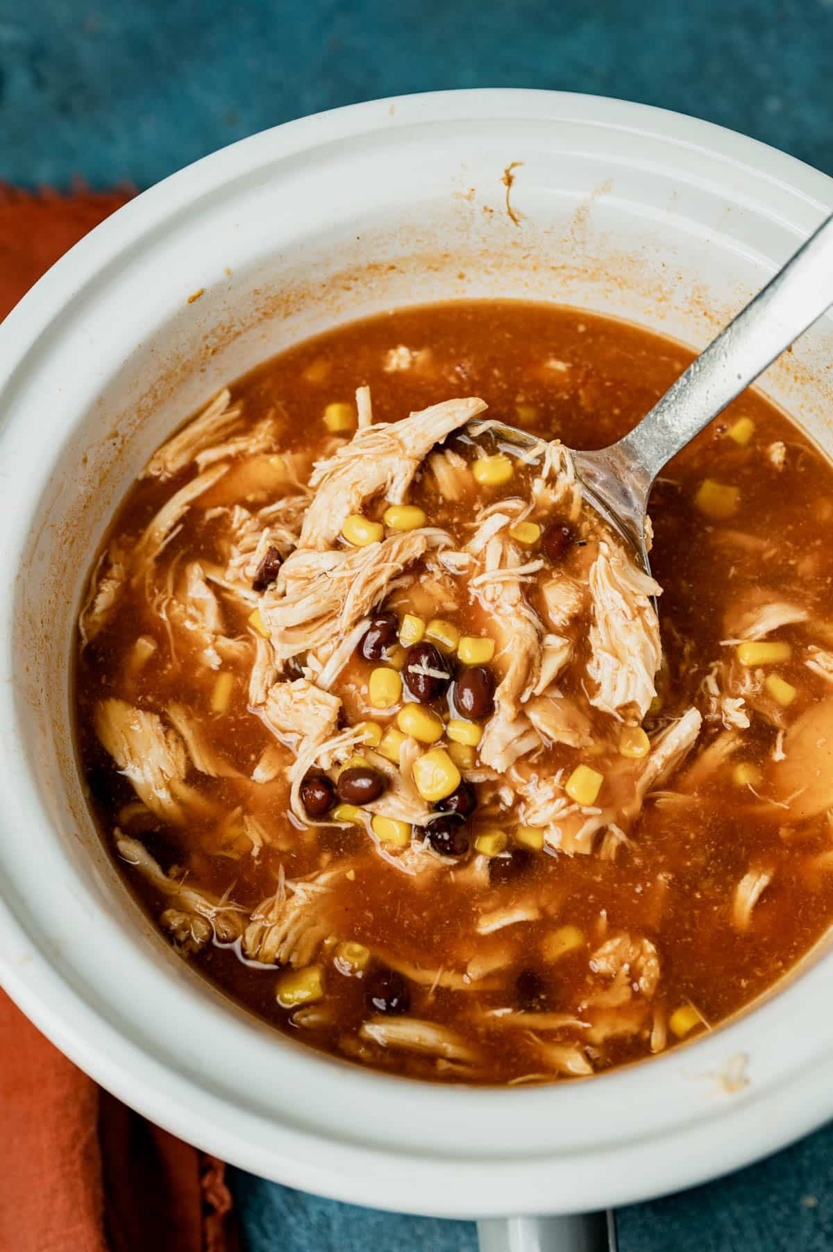 bbq chicken soup in a slow cooker with a ladle