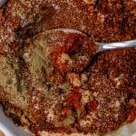 overhead view of spices in a white bowl with a spoon