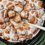 cinnamon roll bites in a skillet with a fork