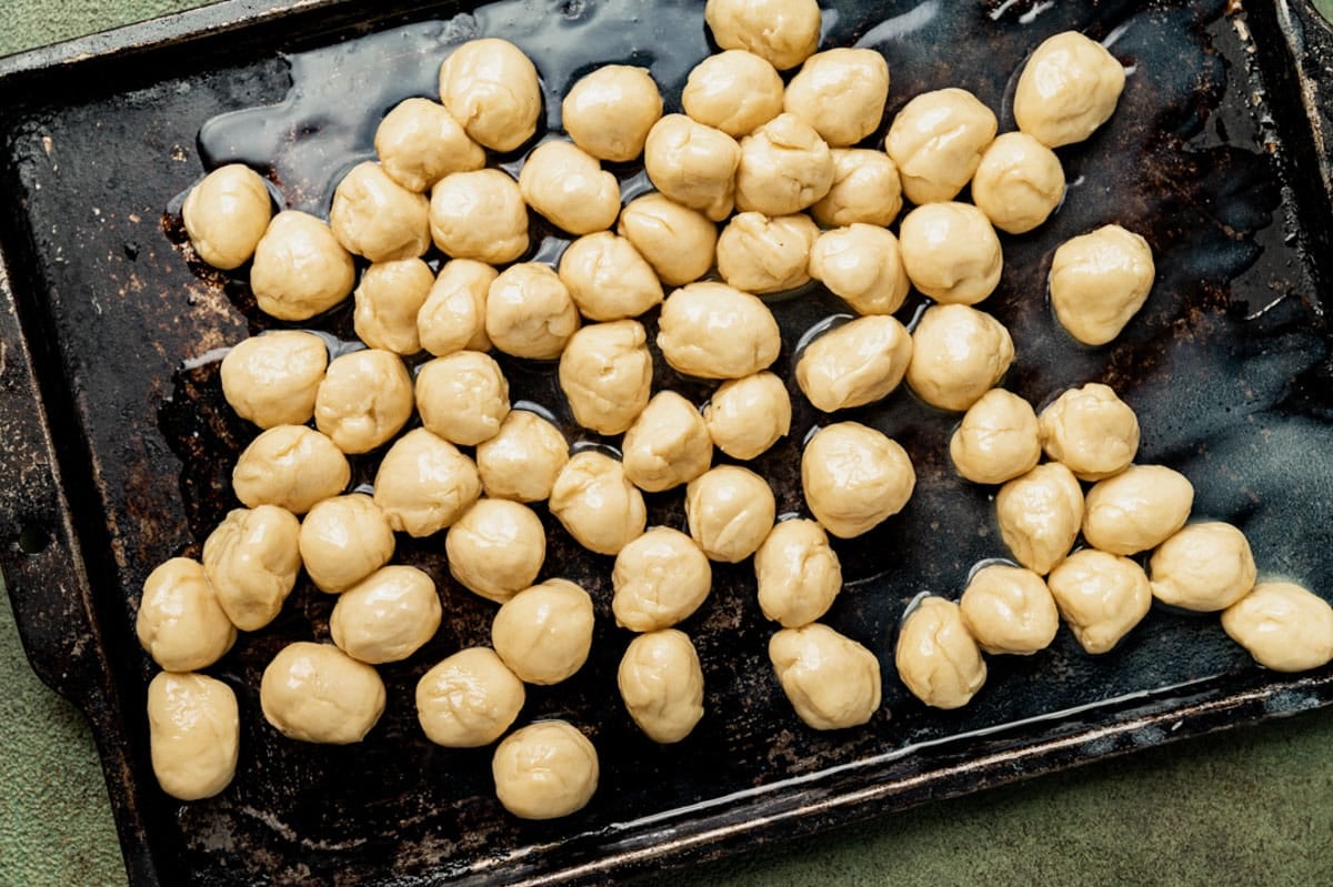 dough balls on a baking sheet in butter