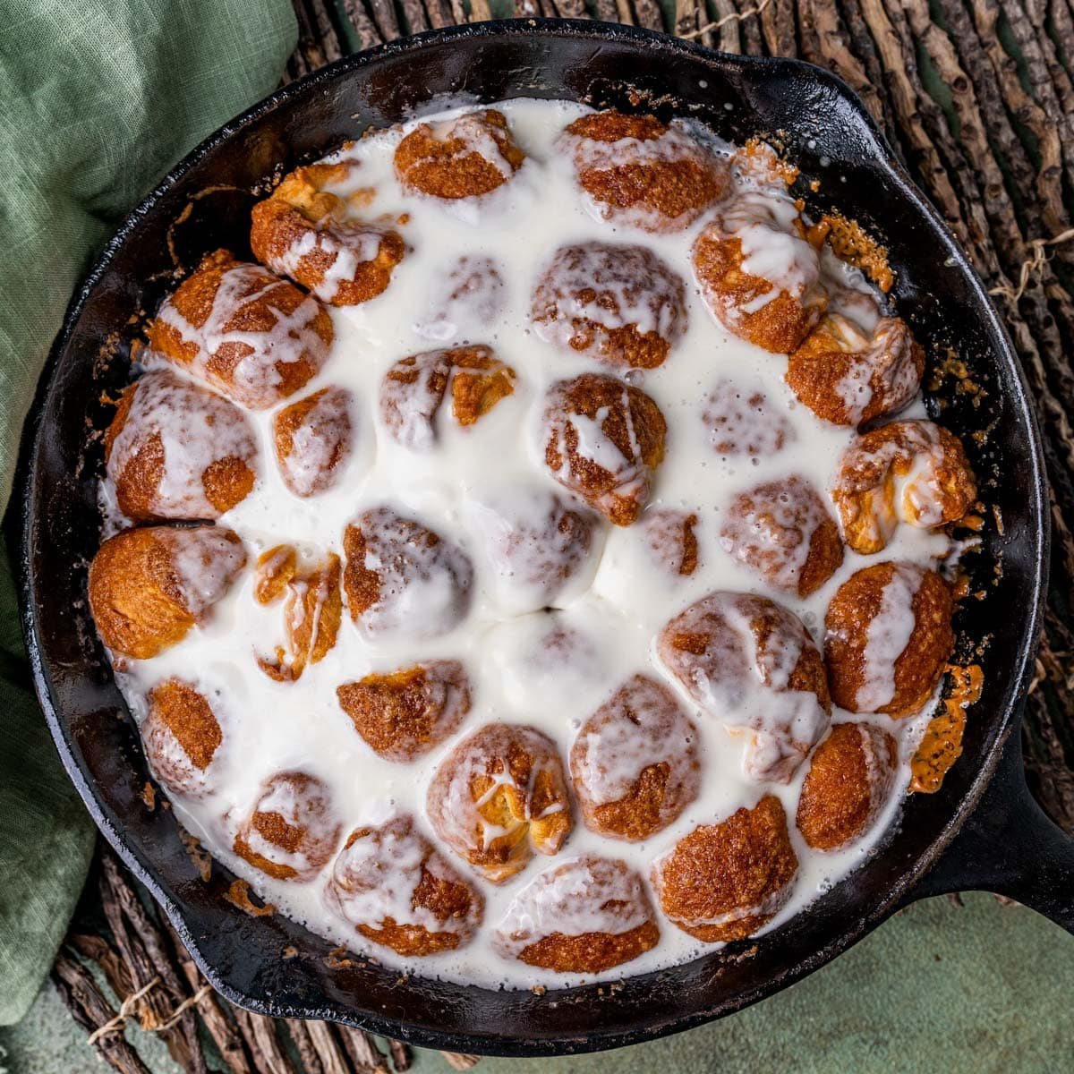 overhead view of cinnamon roll bites in a skillet