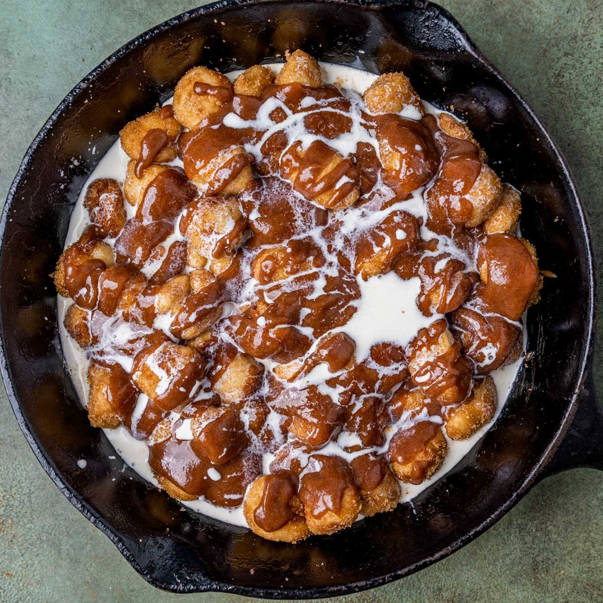dough balls with cinnamon glaze and heavy cream overtop