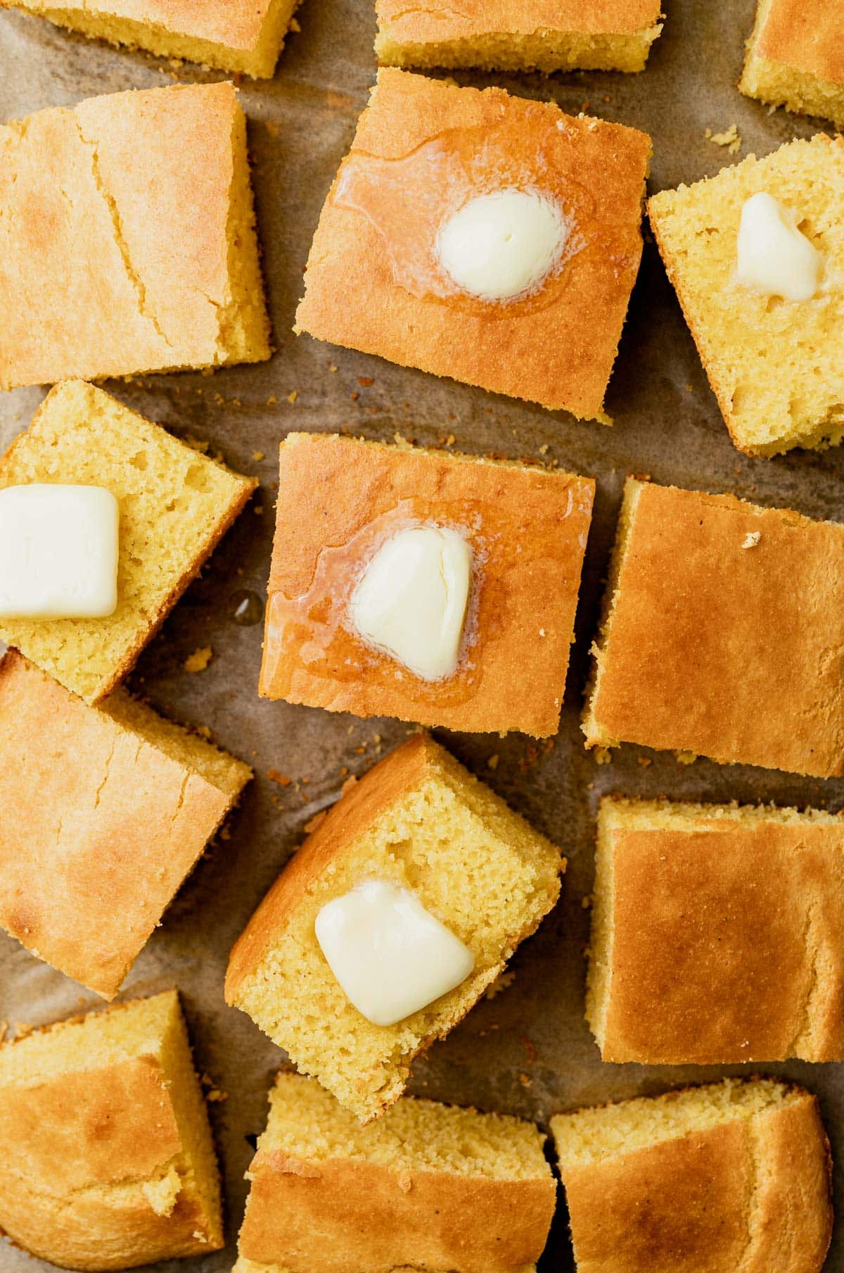 overhead view of cornbread cakes with butter and honey