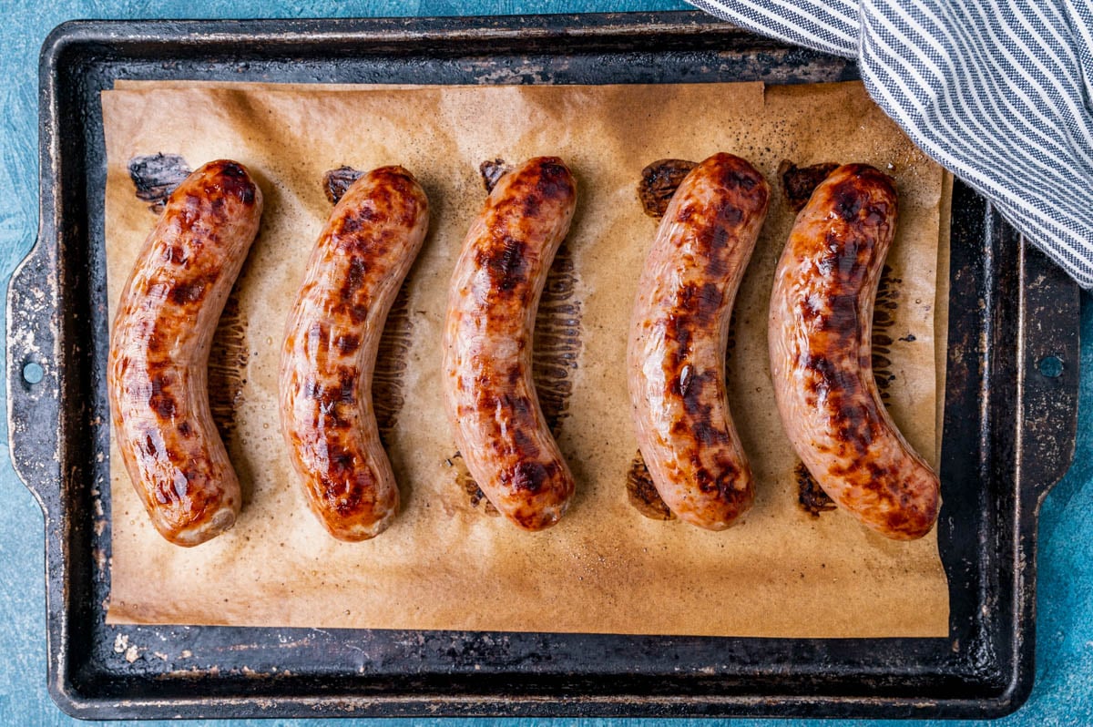 oven baked bratwurst on a baking pan