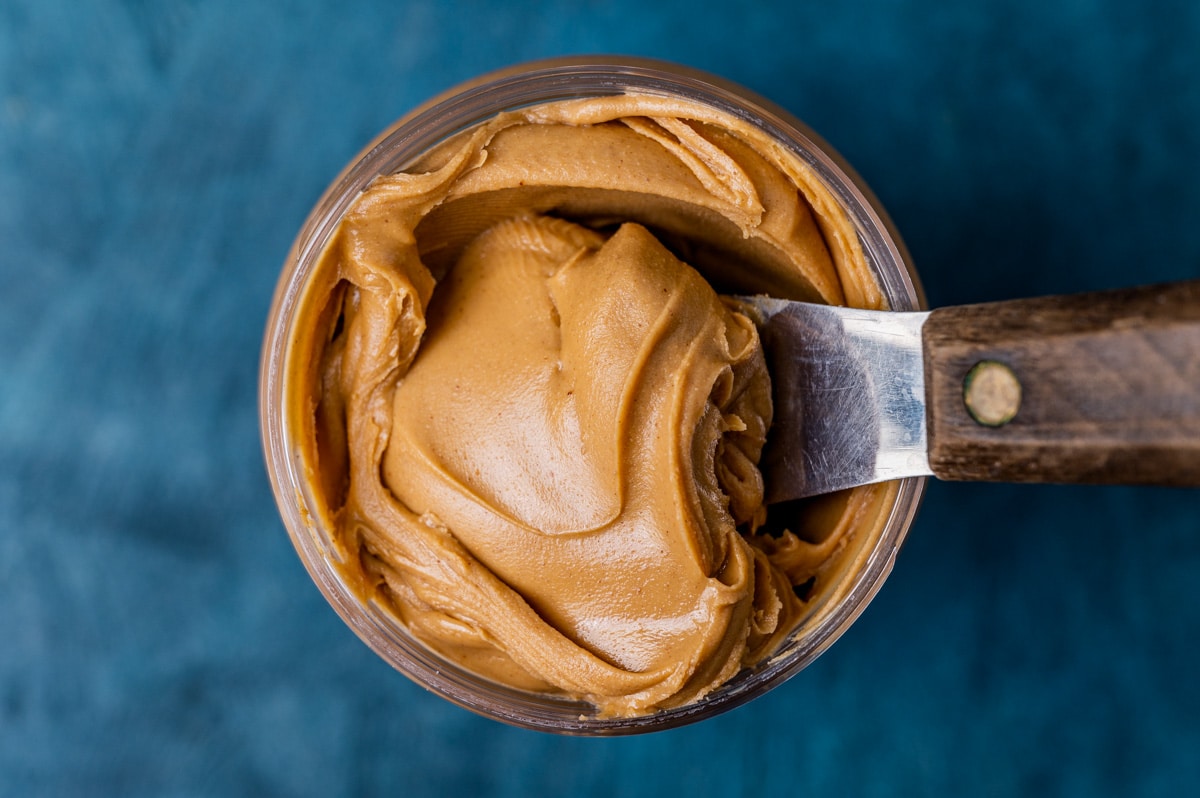 peanut butter in a jar with a knife