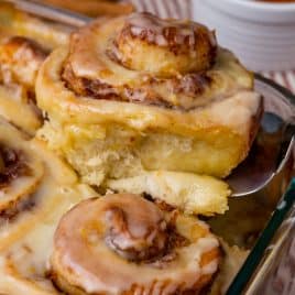 an orange cinnamon roll on a spatula