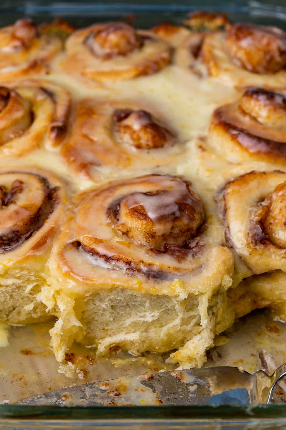 glazed orange rolls in a baking pan