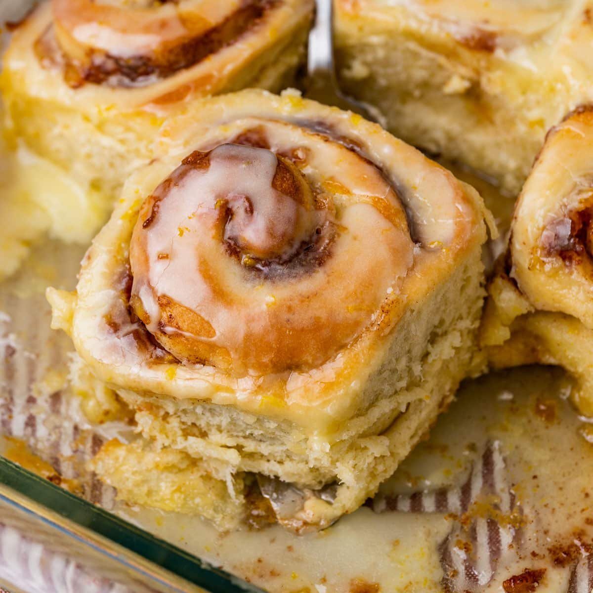 an orange cinnamon roll in a baking pan