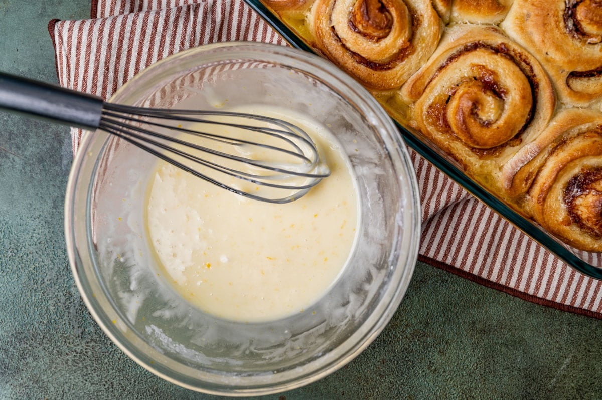 orange glaze in a bowl with a whisk