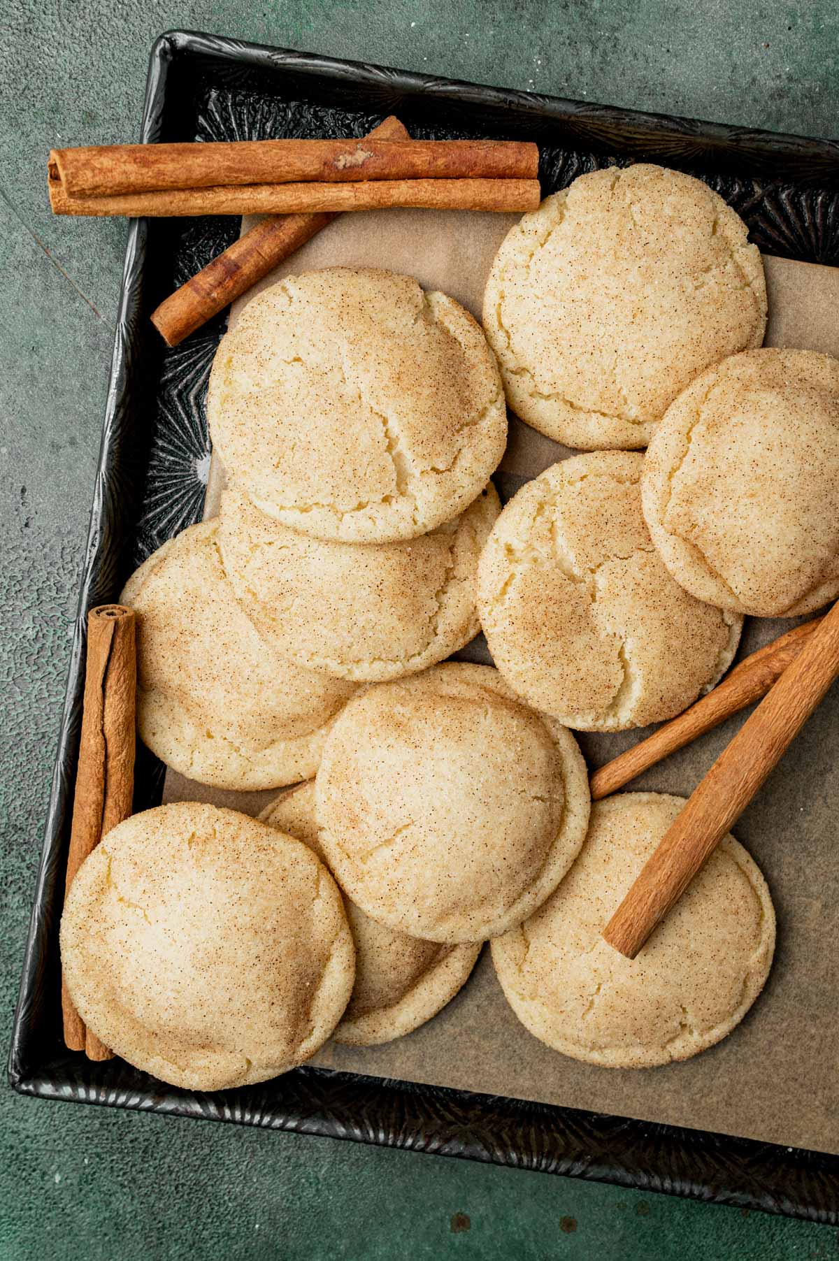 overhead view of a pile of snickerdoodles on a pan