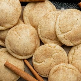 a pile of snickerdoodle cookies sitting on a cookie sheet