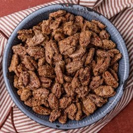 a bowl of candied pecans on a table