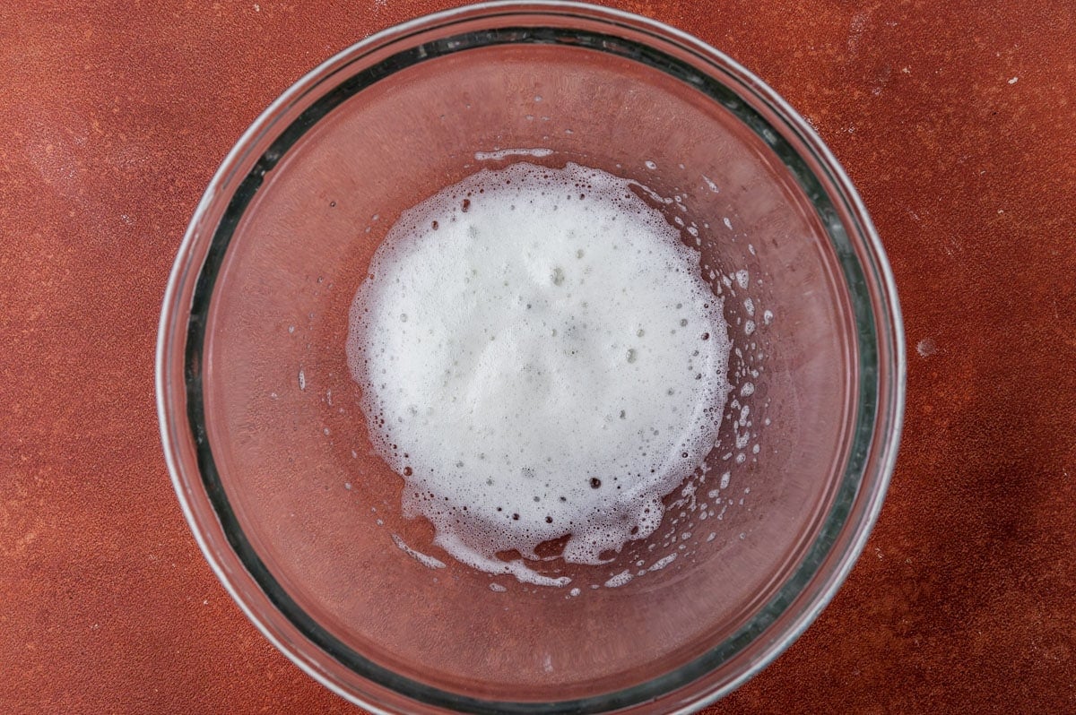 egg white frothed in a glass bowl