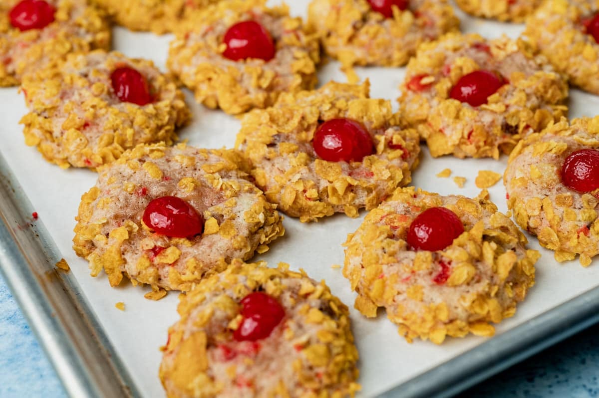 cherry wink cookies on a baking sheet with parchment paper