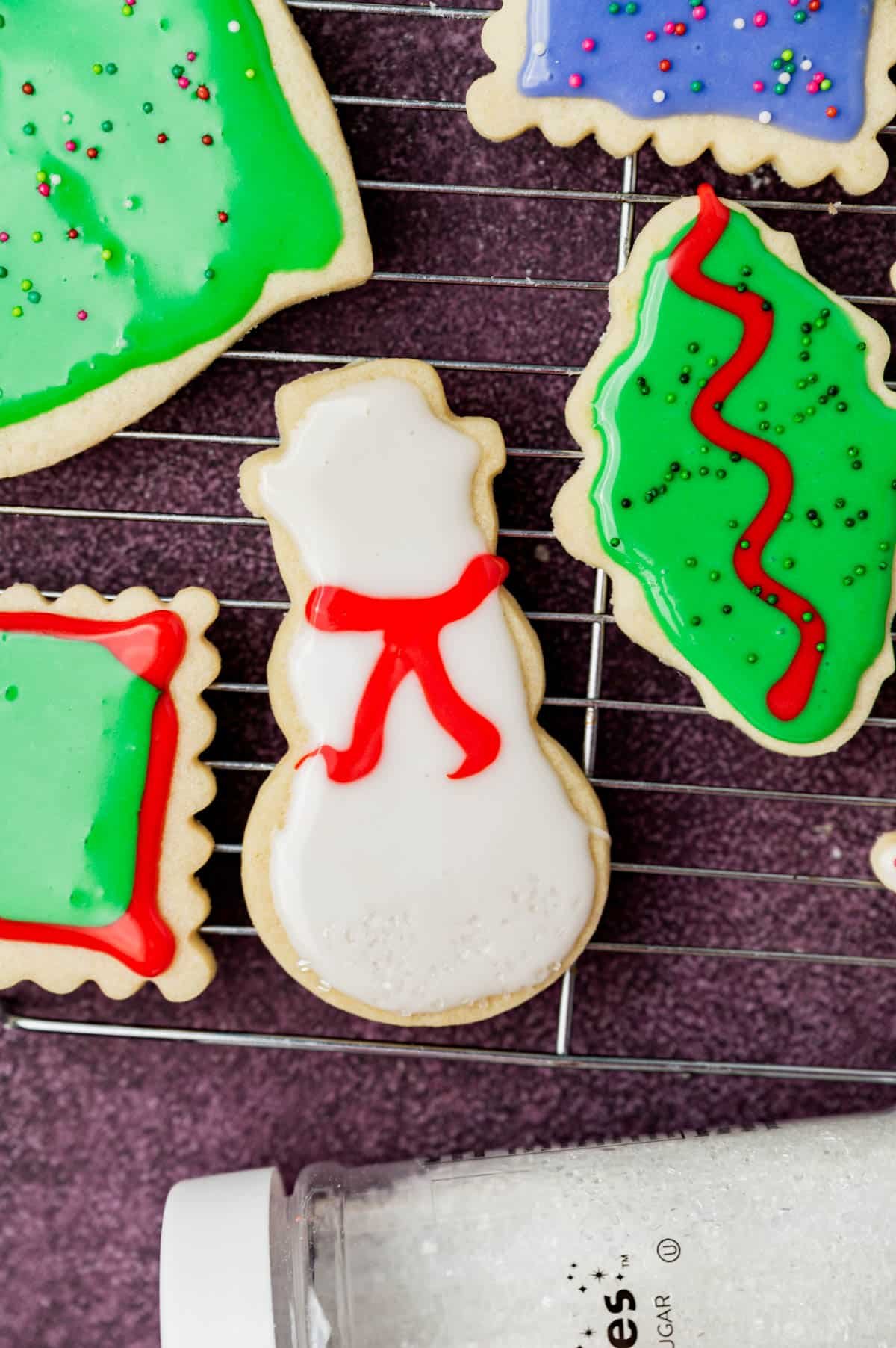 frosted sugar cookies on a wire rack