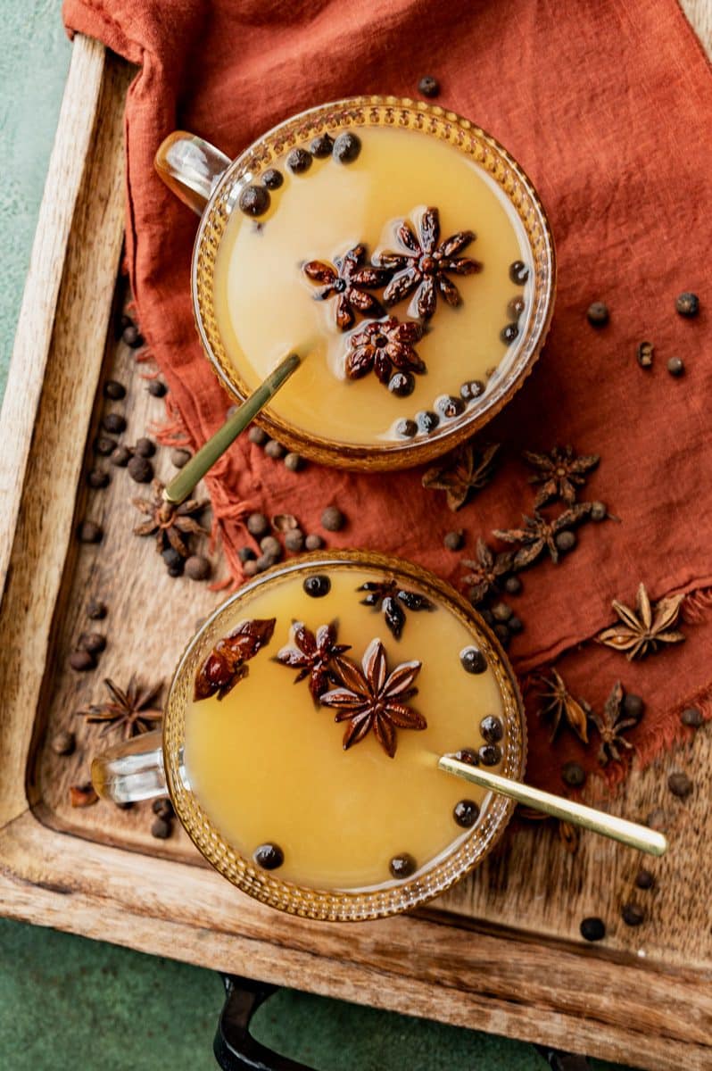 overhead view of two glasses of mulled spiced apple cider