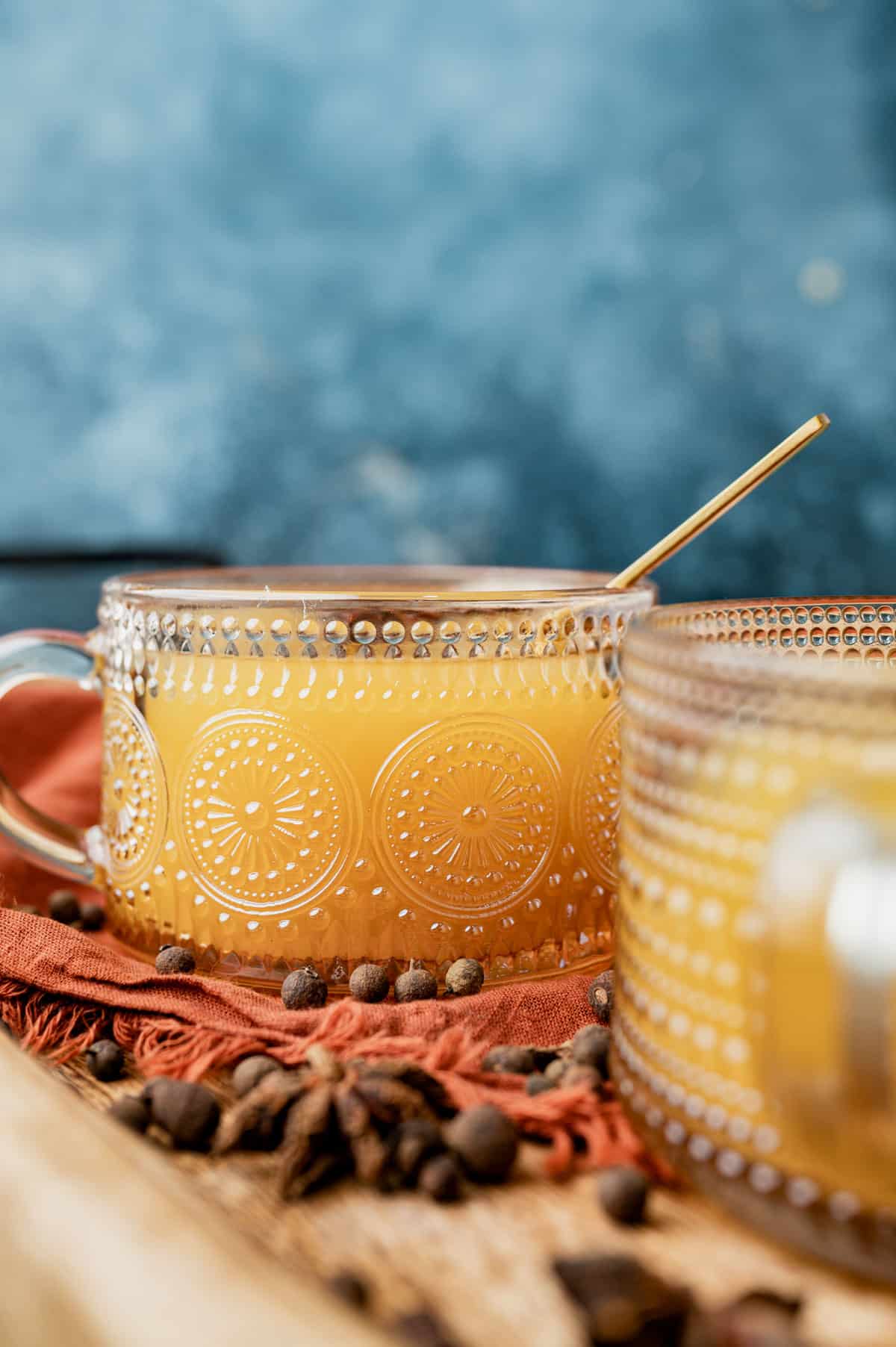 a cup of spiced cider sitting on a table