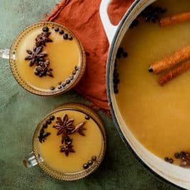 overhead view of two glasses of mulled cider on a table