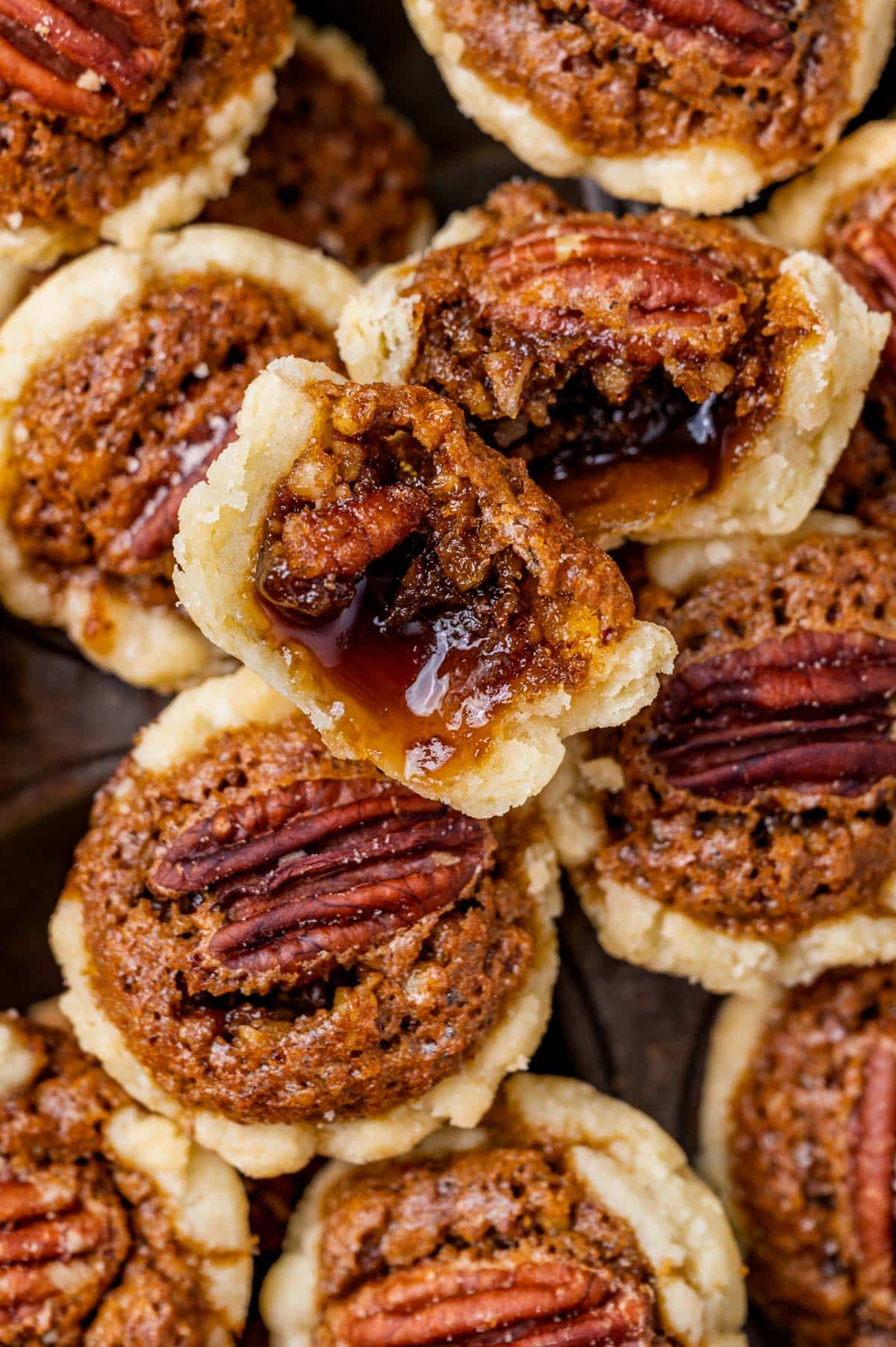 closeup of pecan tassie cookies, one cut in half