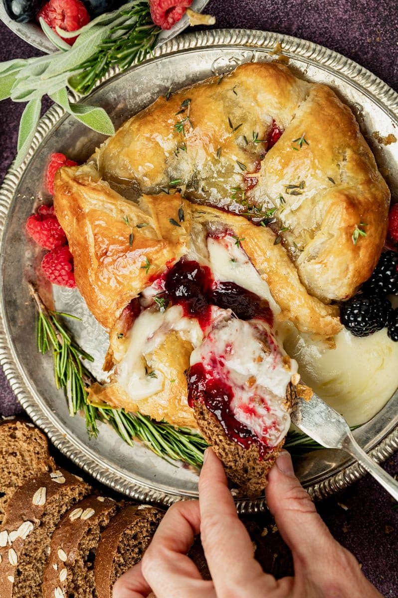 overhead view of puff pastry wrapped brie on a plate