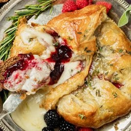 overhead view of puff pastry baked brie with jam