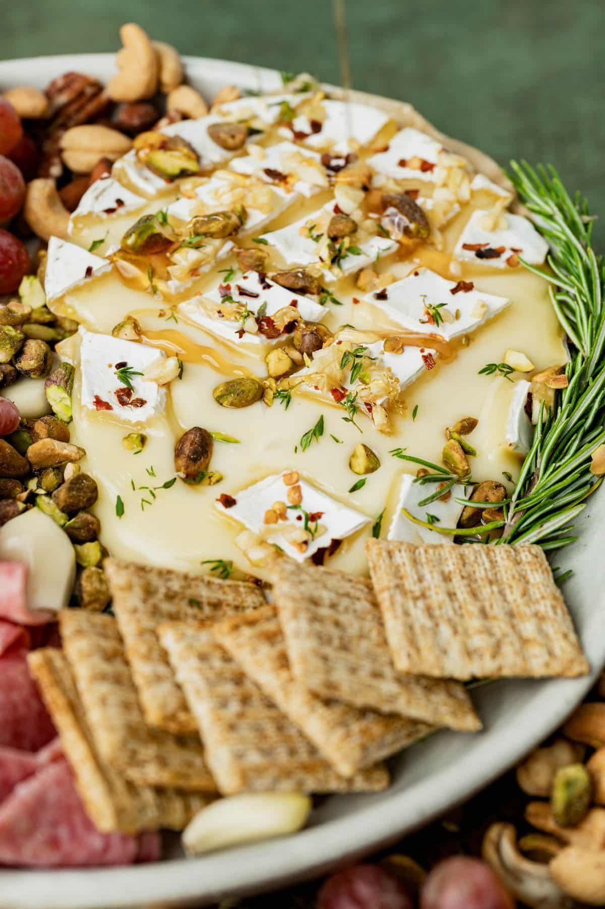 baked brie with hot honey on a plate with crackers