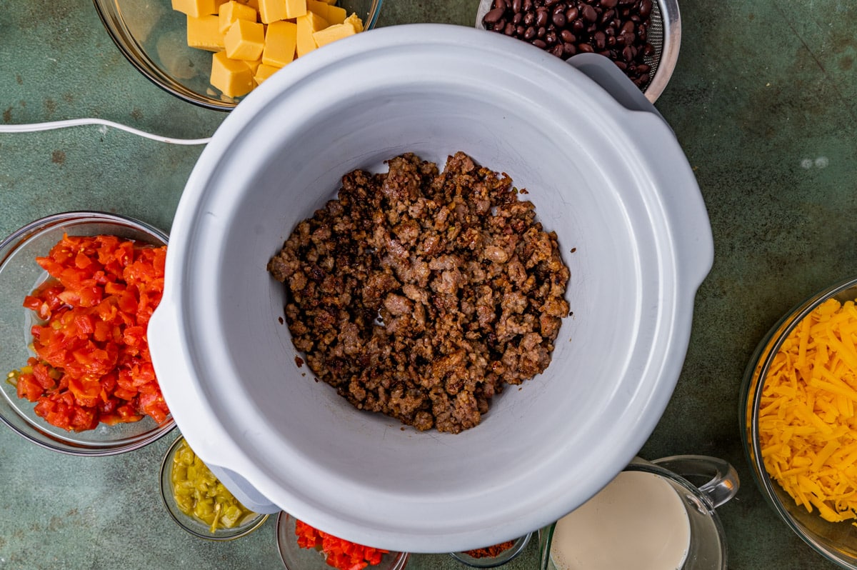 cooked and crumbled sausage in a slow cooker