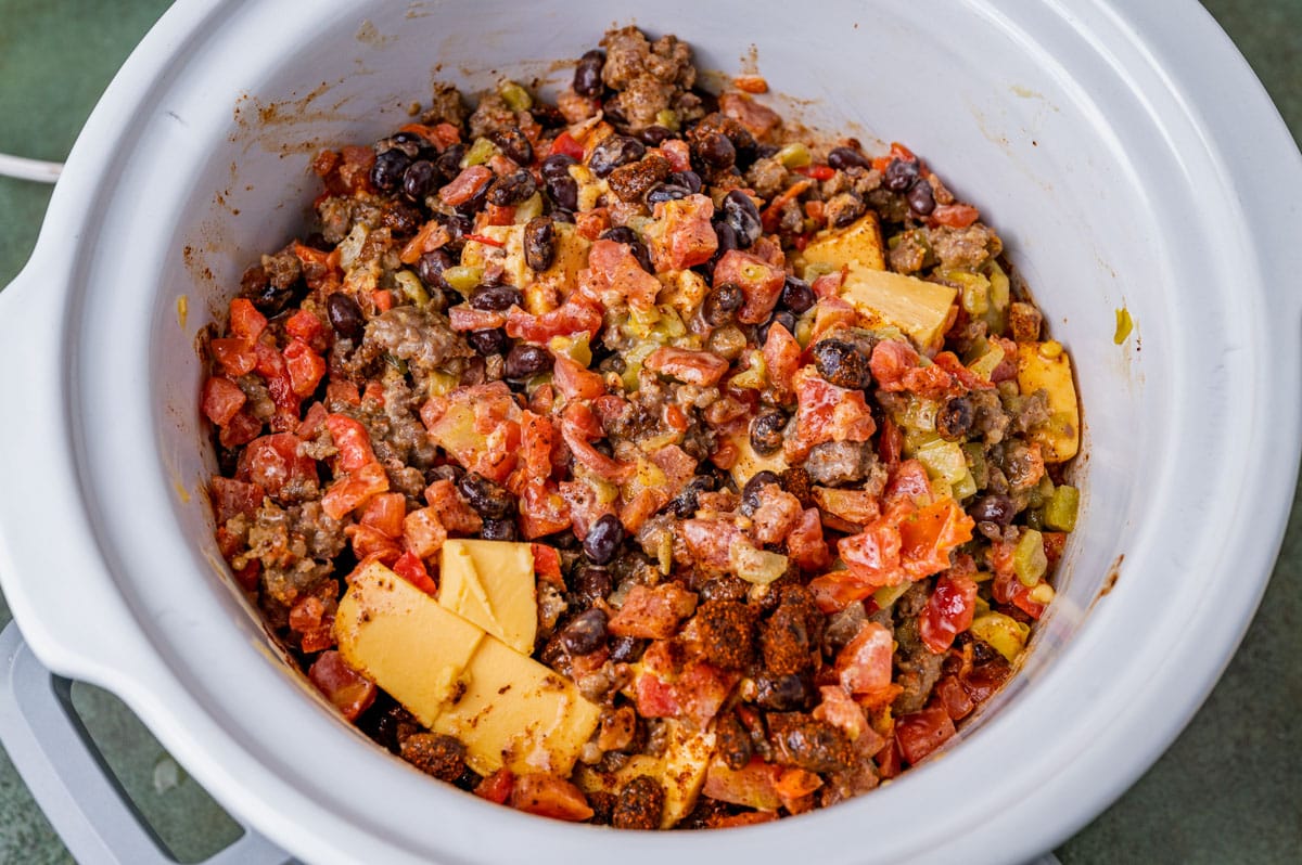 beans, tomatoes, sausage and cheese in a slow cooker