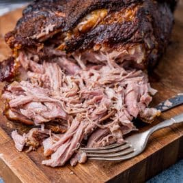 shredded pork on a cutting board