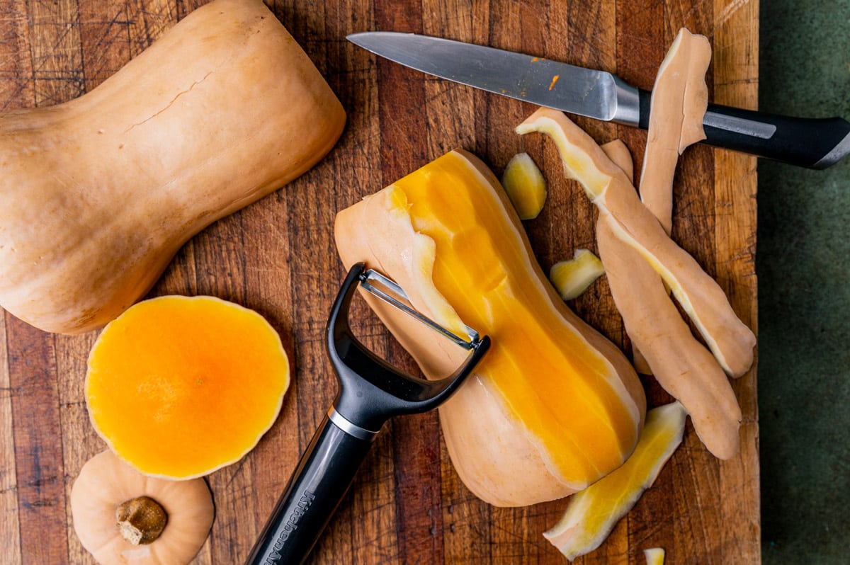 vegetable peeler peeling skin off a butternut squash