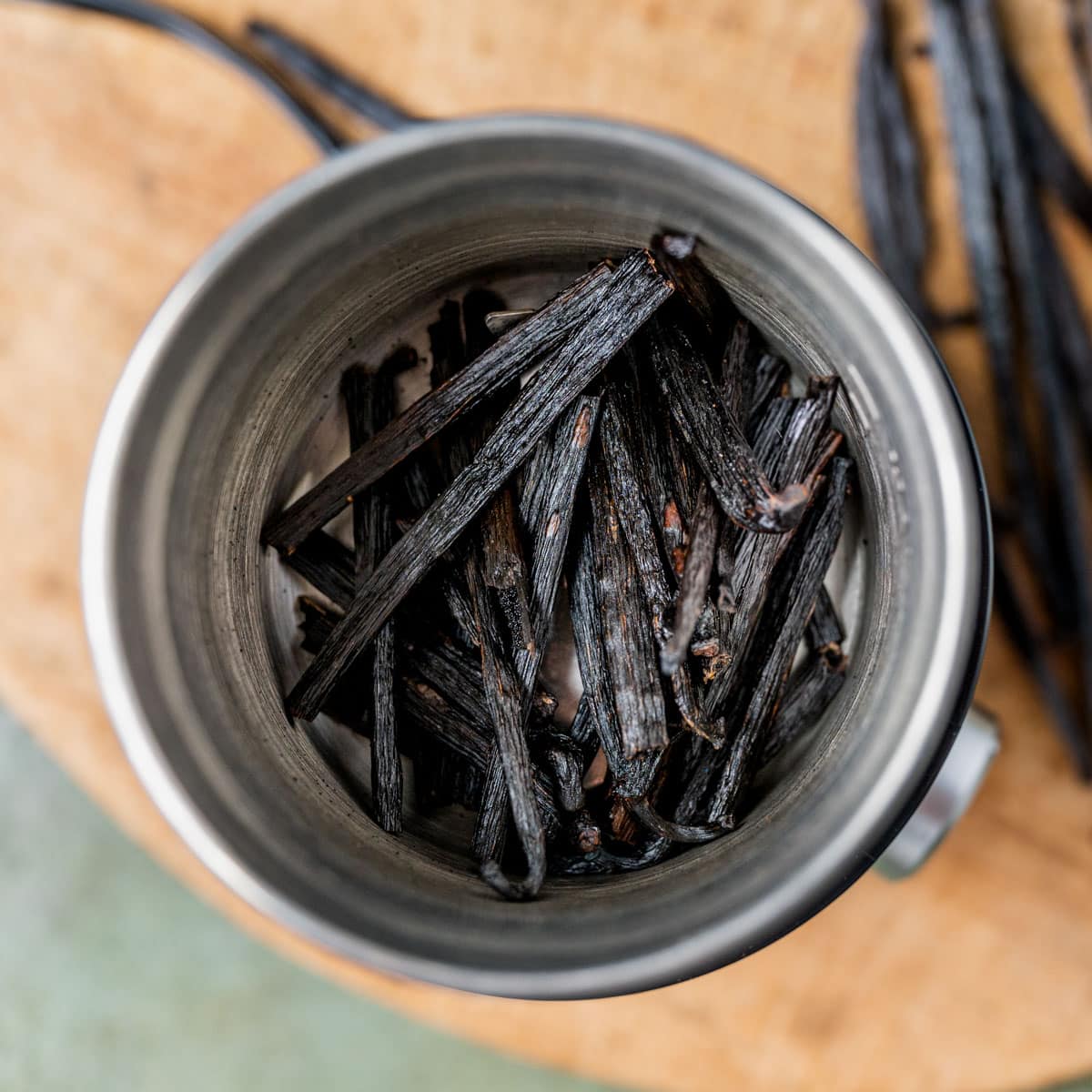 dried vanilla beans in a coffee grinder