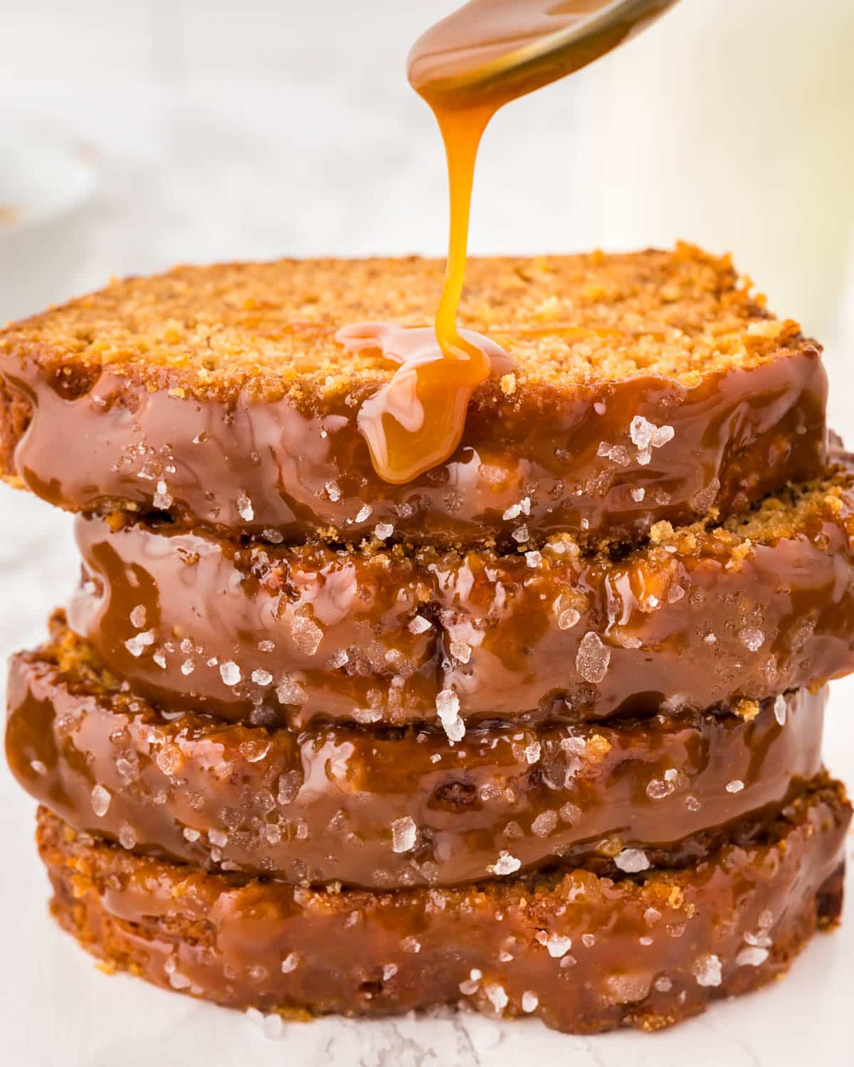 caramel drizzling over slices of banana bread